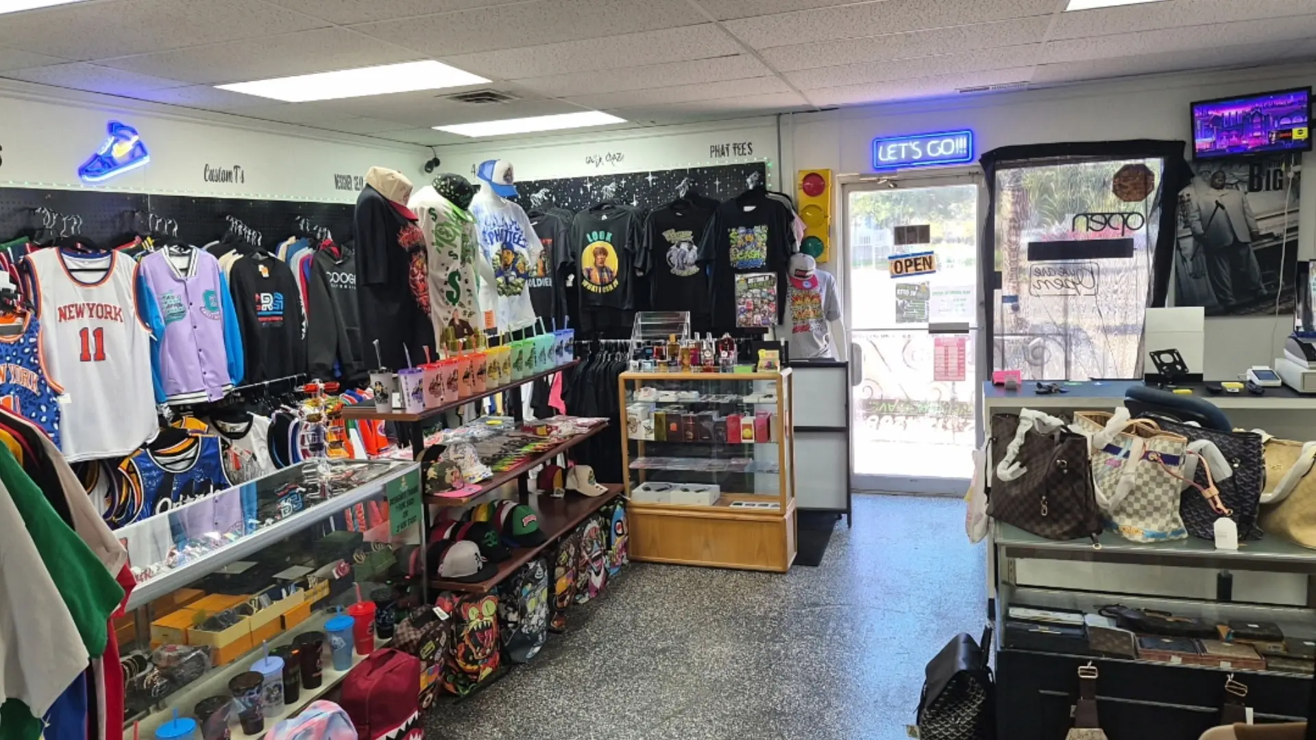 Inside Phat Tees looking toward the front entrance and Let's Go sign